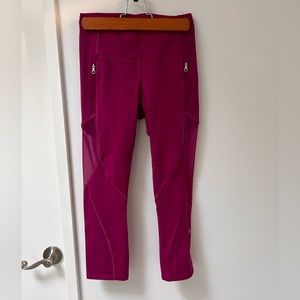 Lululemon cropped leggings, bright pink with mesh panels and zipper pockets